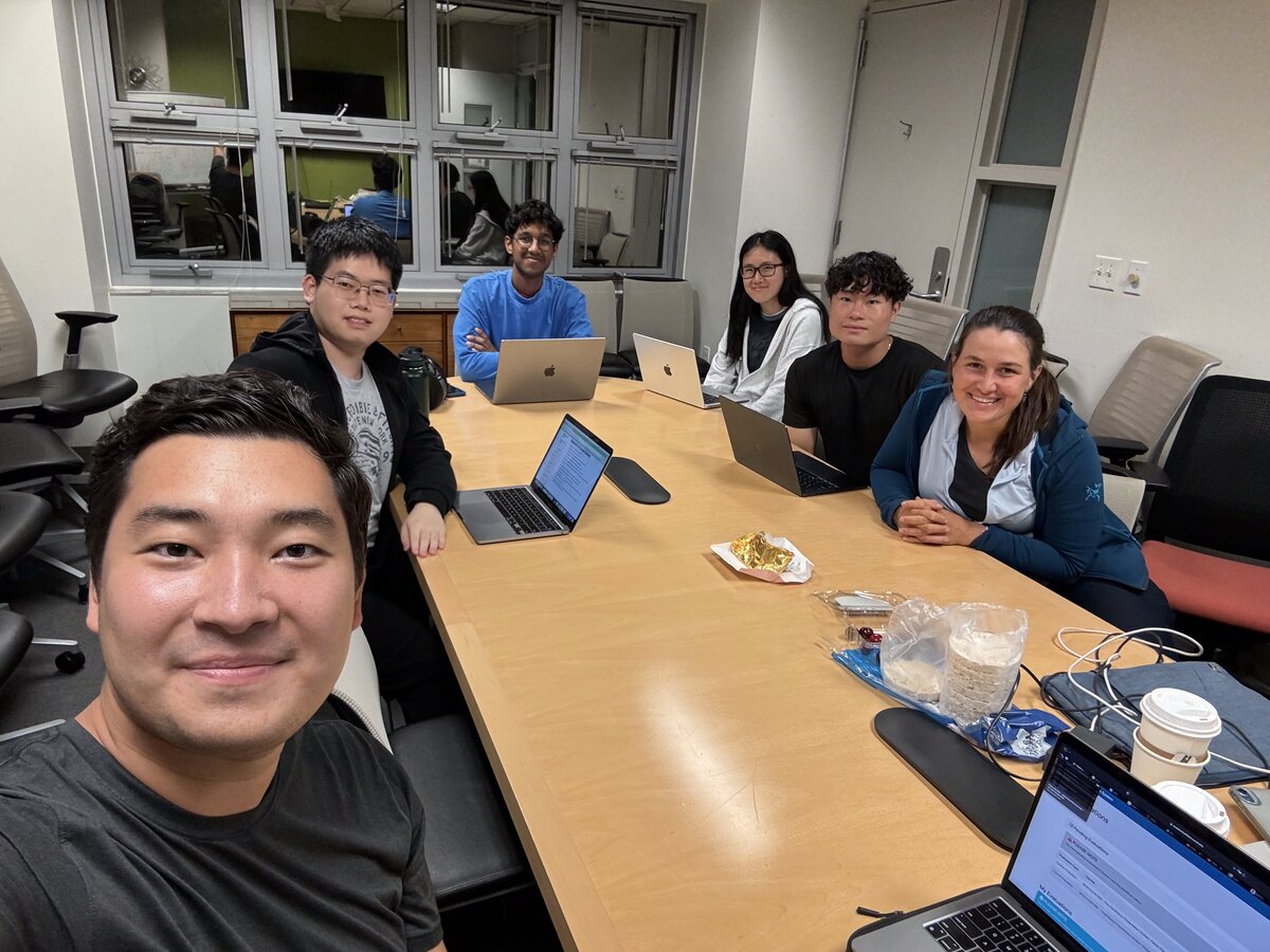 Lab meeting with students working on laptops